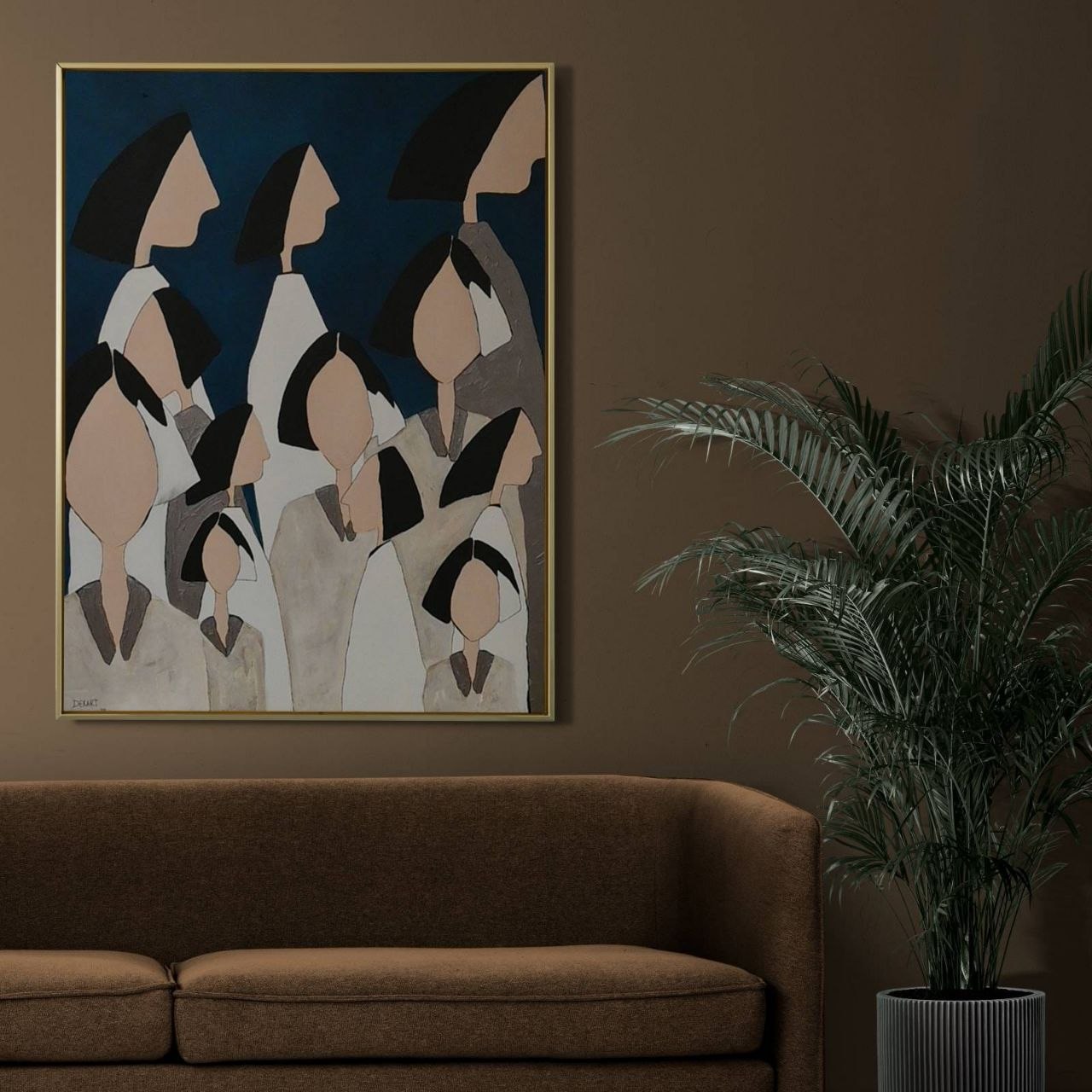 Dekart painting above a sofa in a dark-toned room.